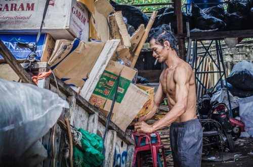 Packing trash onto cart in Jakarta