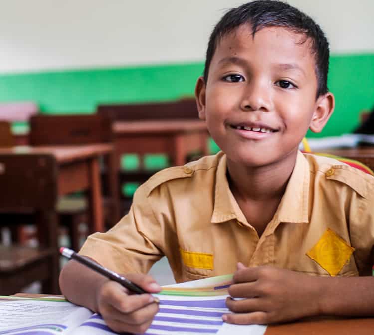 Boy sponsored by XSProject studying in class Boy sponsored by XSProject studying in class
