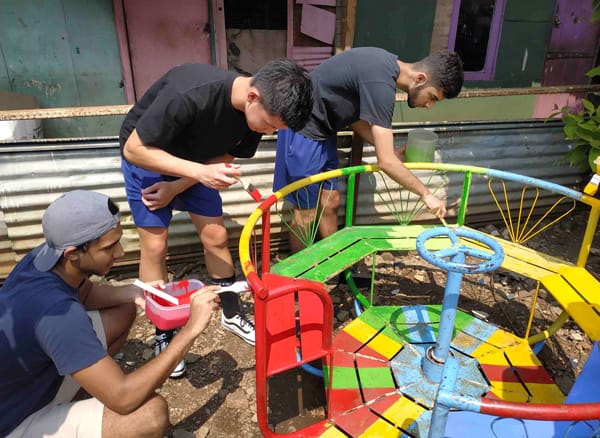 Volunteers painting the playground